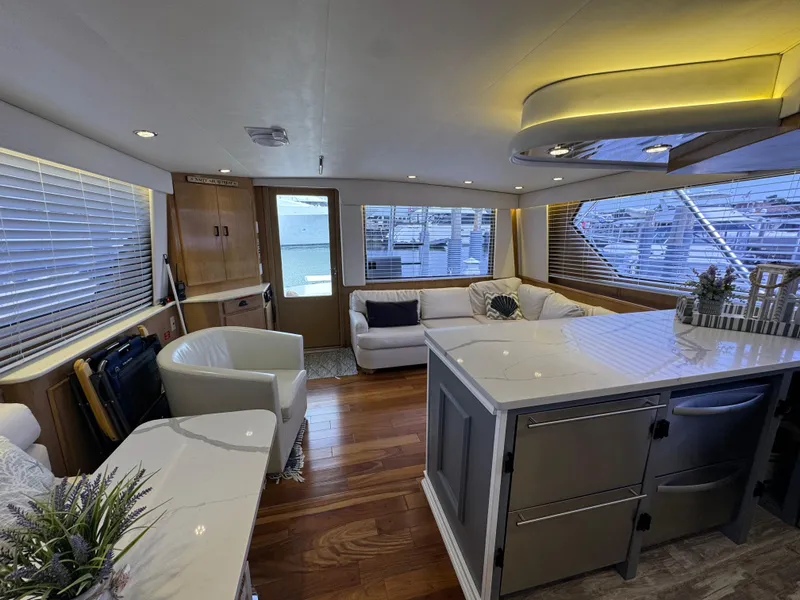 Slide: The Image of Luxurious interior of a 1994 Hatteras 54 Convertible yacht with modern furnishings. - 27