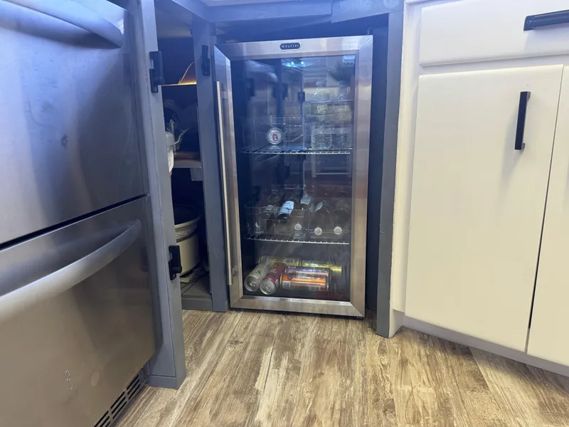 Slide: The Image of Mini fridge stocked with beverages in a modern kitchen on a 1994 Hatteras 54 Convertible. - 28