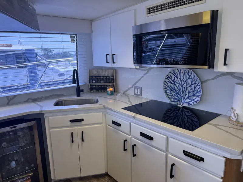 Slide: The Image of Modern kitchen interior of 1994 Hatteras 54 Convertible yacht with sleek appliances and cabinetry. - 29