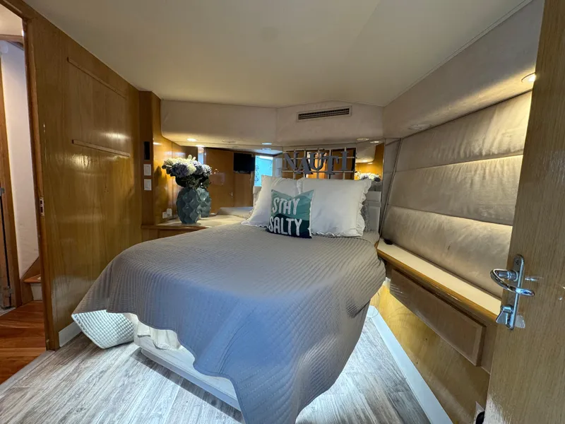 Slide: The Image of Luxurious bedroom interior of 1994 Hatteras 54 Convertible yacht with cozy bedding. - 31