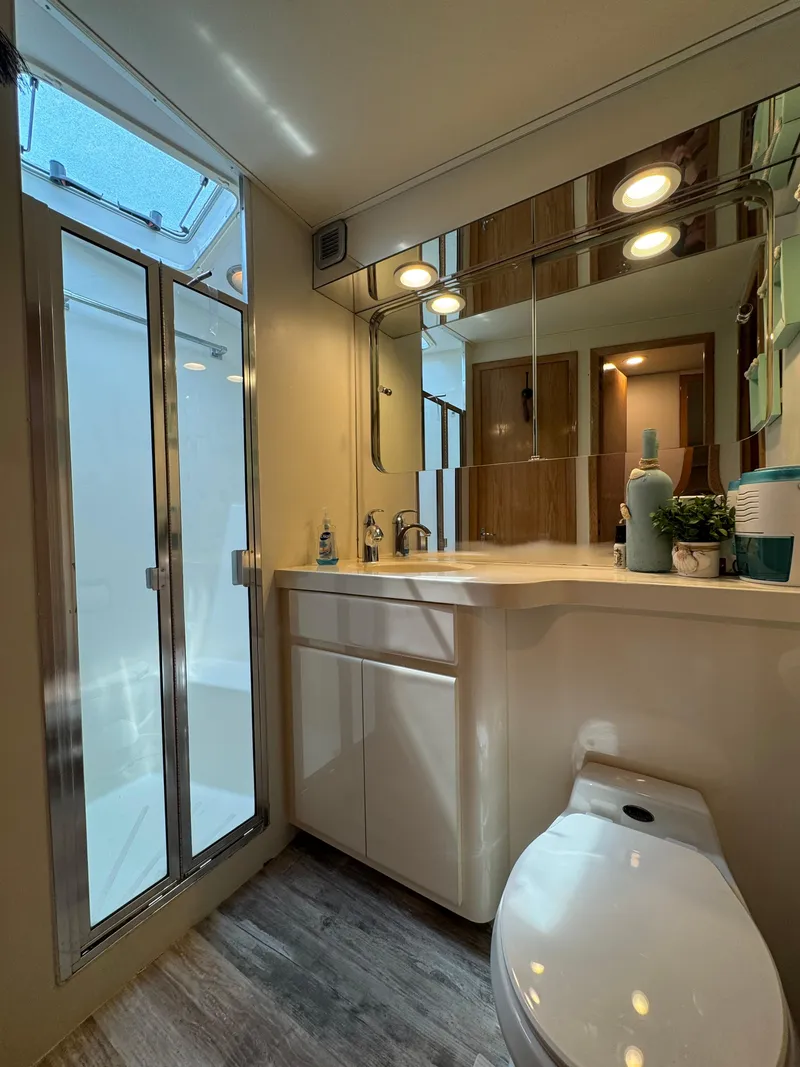 Slide: The Image of Bathroom interior of 1994 Hatteras 54 Convertible yacht with shower and modern fixtures. - 35