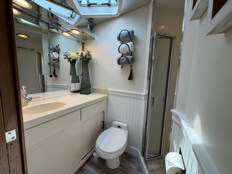 Slide: The Image of Bathroom interior of 1994 Hatteras 54 Convertible yacht, featuring modern fixtures and elegant decor. - 36