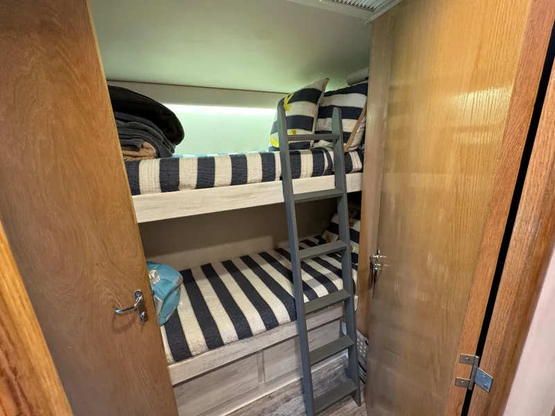 Slide: The Image of Bunk beds with striped bedding in 1994 Hatteras 54 Convertible yacht cabin. - 39