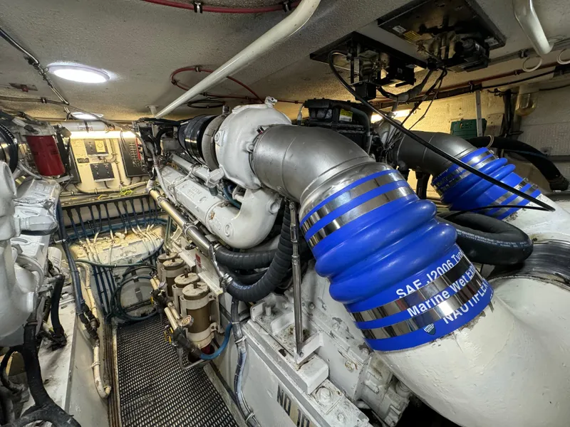 Slide: The Image of Engine room of a 1994 Hatteras 54 Convertible yacht, showcasing complex machinery and components. - 41