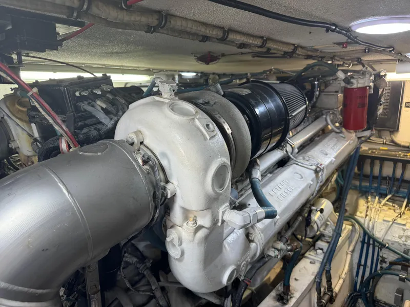 Slide: The Image of Engine room of a 1994 Hatteras 54 Convertible yacht, showcasing detailed machinery. - 43