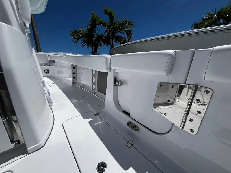 Slide: The Image of 2024 Sportsman 322 OPEN CC boat interior with white seating and stainless steel hardware. - 14