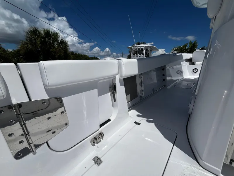 Slide: The Image of 2024 Sportsman 322 OPEN CC boat interior with white seating and stainless steel hardware. - 15