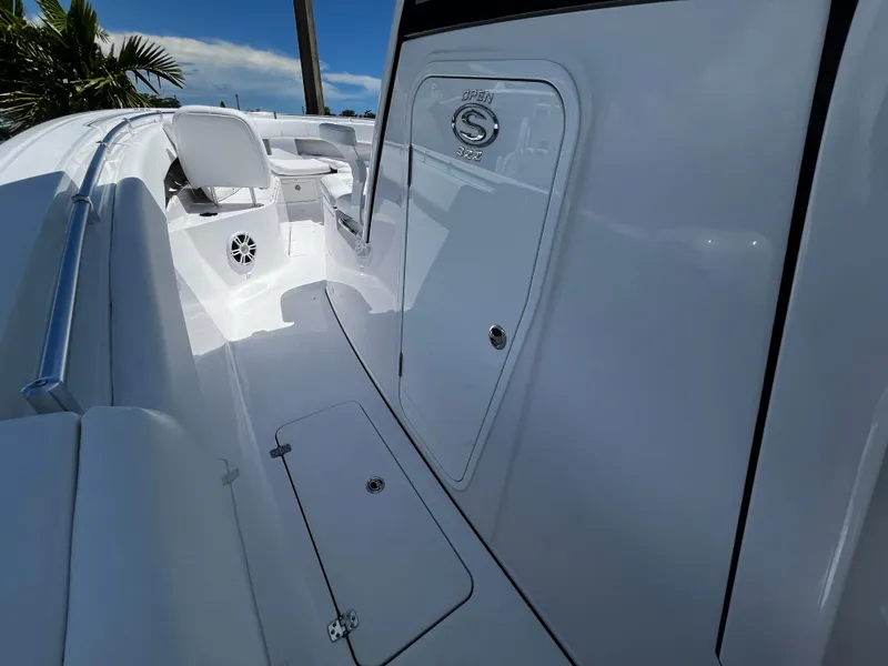 Slide: The Image of 2024 Sportsman 322 OPEN CC boat interior, white deck and seating area. - 16