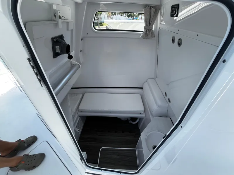 Slide: The Image of 2024 Sportsman 322 OPEN CC interior cabin with seating and window. - 17