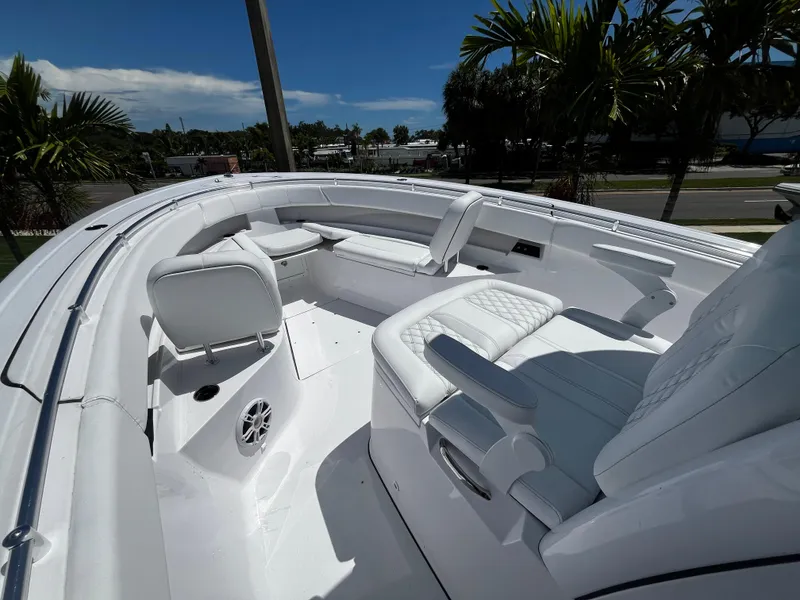 Slide: The Image of 2024 Sportsman 322 OPEN CC boat interior with white seating and modern design. - 18
