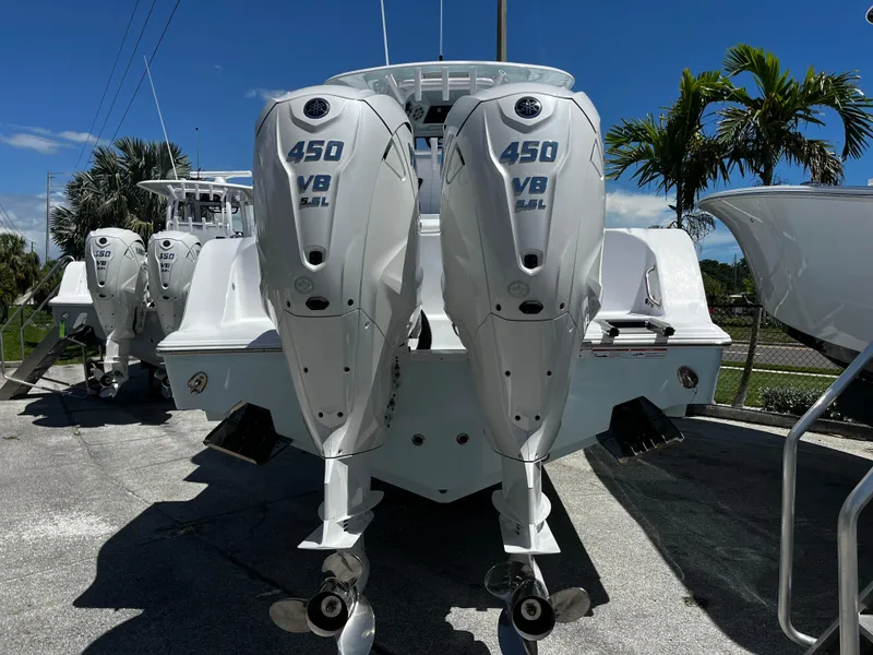 Slide: The Image of 2024 Sportsman 322 OPEN CC with twin 450 V8 outboard engines. - 2