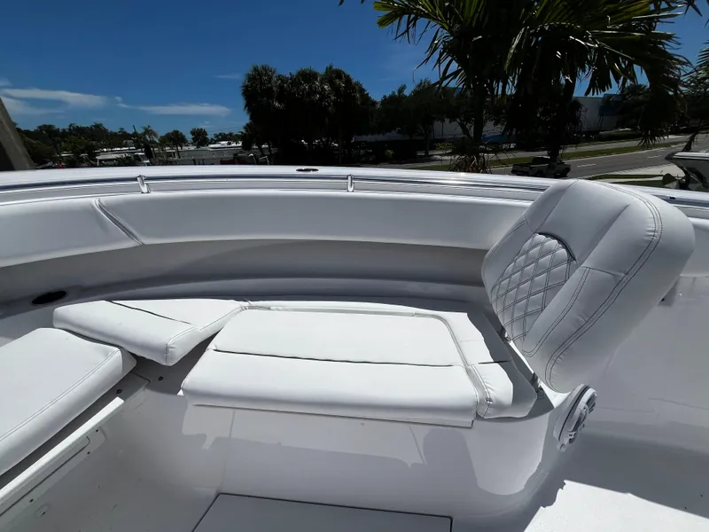 Slide: The Image of 2024 Sportsman 322 OPEN CC boat with white cushioned seating. - 20