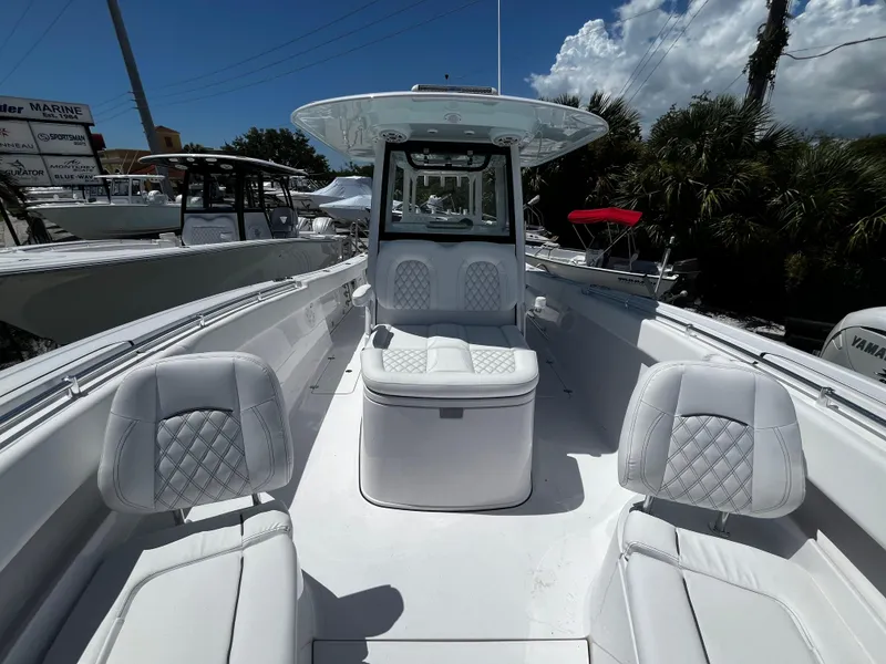 Slide: The Image of 2024 Sportsman 322 OPEN CC boat with white seating and center console. - 21