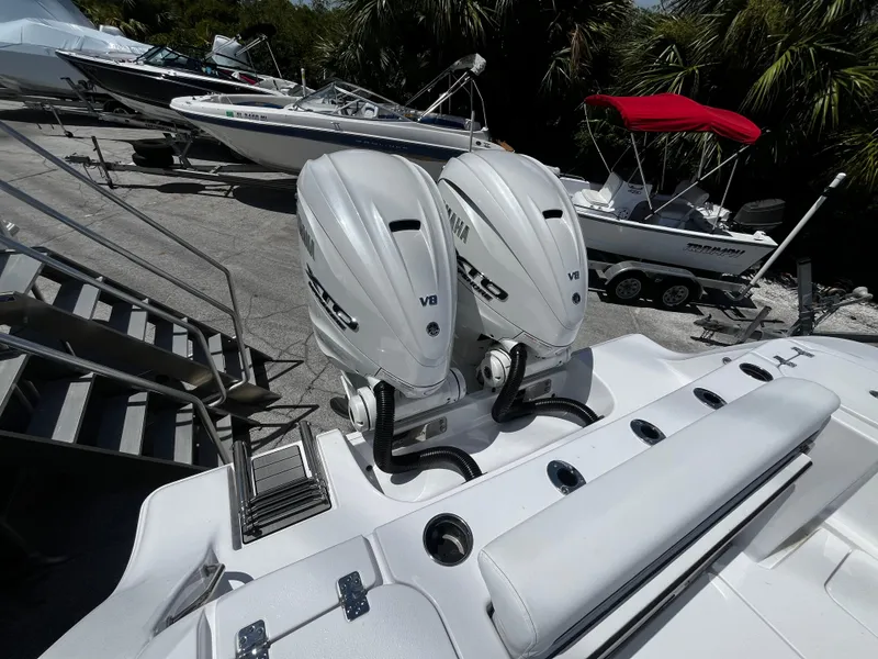 Slide: The Image of 2024 Sportsman 322 OPEN CC boat with twin V8 engines in a marina. - 3