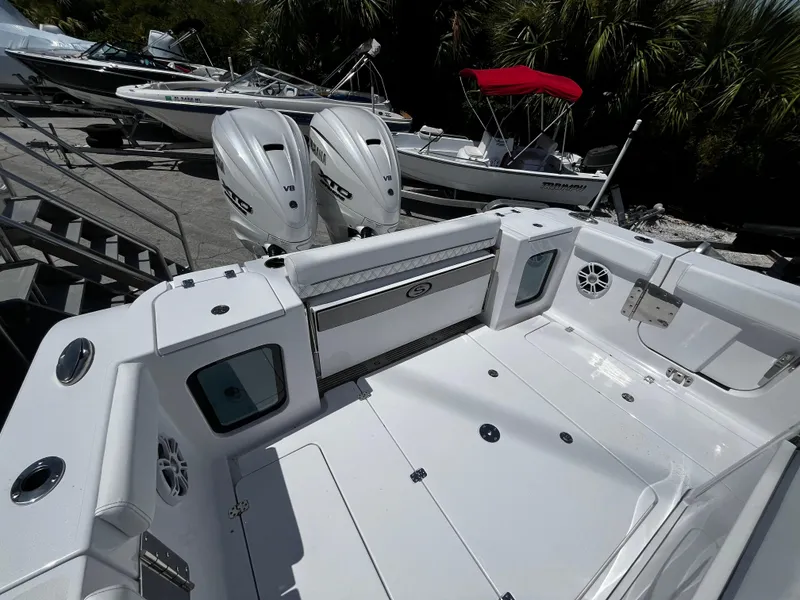 Slide: The Image of 2024 Sportsman 322 OPEN CC boat with dual outboard engines and spacious deck. - 4