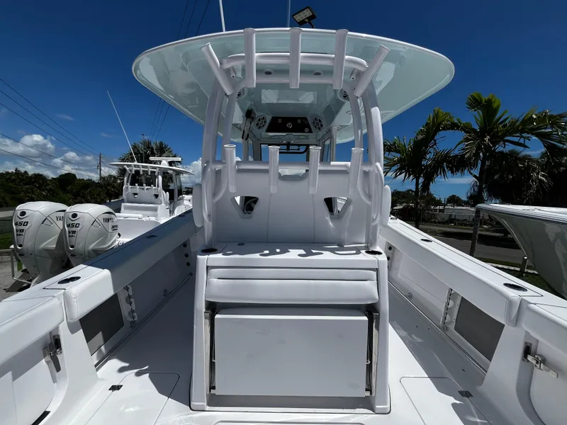 Slide: The Image of 2024 Sportsman 322 OPEN CC center console boat, white interior, dual outboard engines. - 6