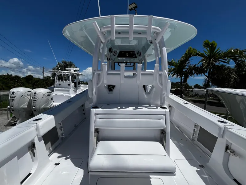 Slide: The Image of 2024 Sportsman 322 OPEN CC center console boat with dual outboard engines. - 7