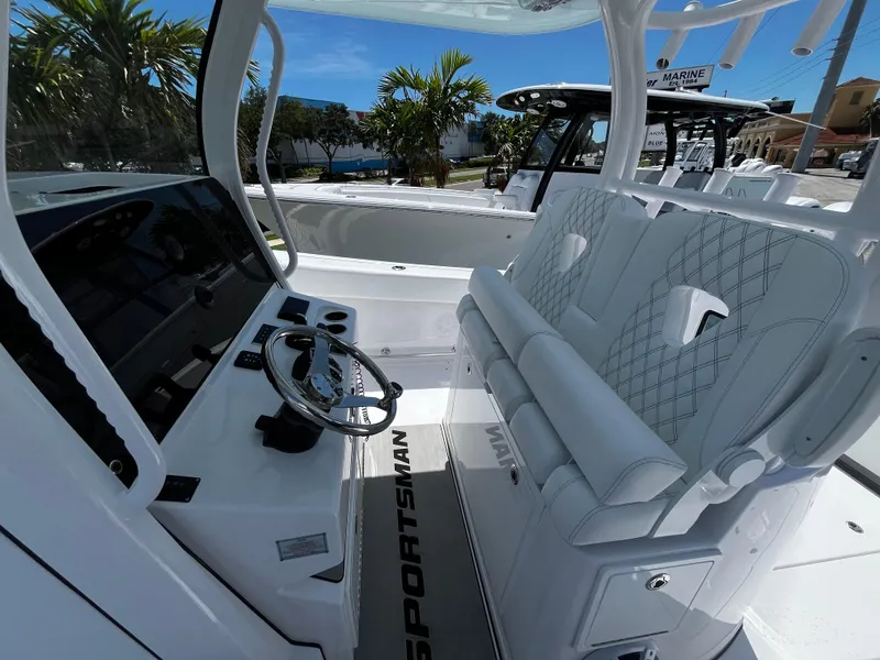 Slide: The Image of 2024 Sportsman 322 OPEN CC boat interior with helm and seating. - 9