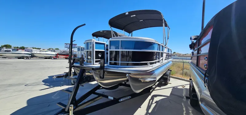 The Image of 2025 South Bay 224FCRLE pontoon boat on trailer in outdoor lot. - 0