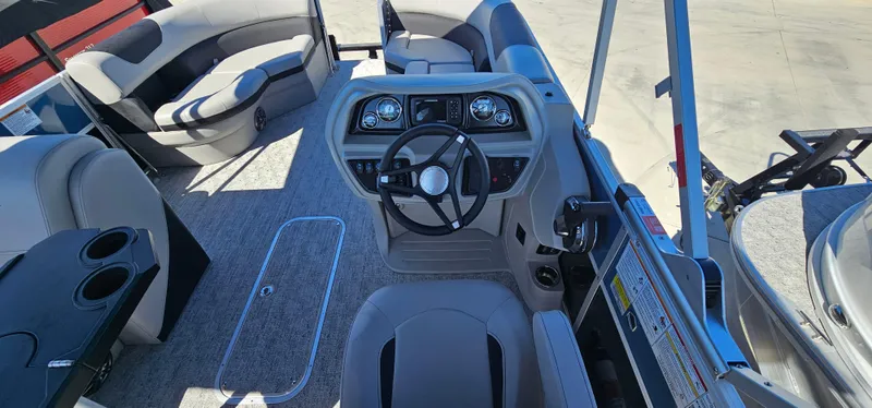 Slide: The Image of 2025 South Bay 224FCRLE boat interior with steering console and seating. - 13