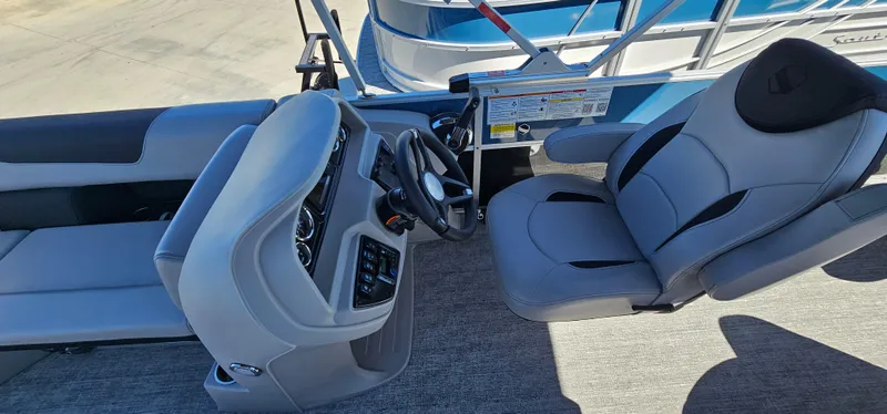 Slide: The Image of 2025 South Bay 224FCRLE boat interior with steering console and seating. - 14