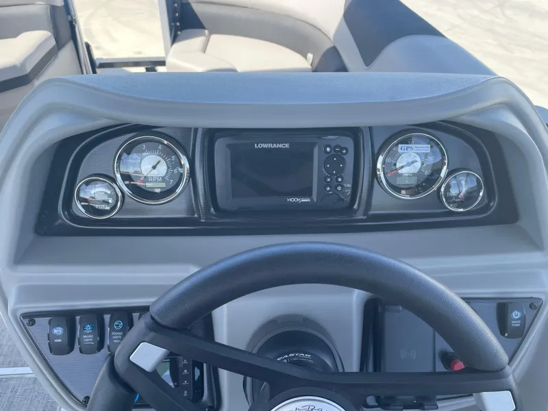 Slide: The Image of 2025 South Bay 224FCRLE boat dashboard with gauges and Lowrance GPS system. - 15