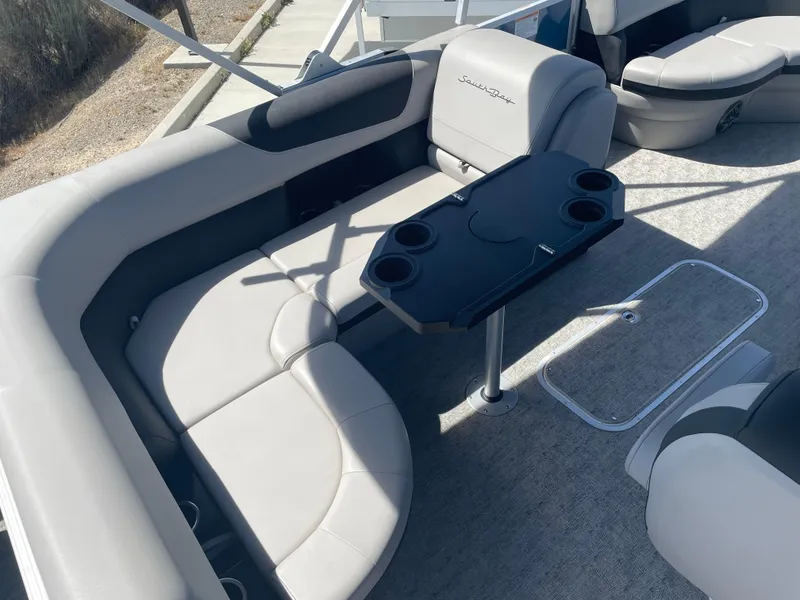 Slide: The Image of 2025 South Bay 224FCRLE boat interior with gray seating and a black table. - 8