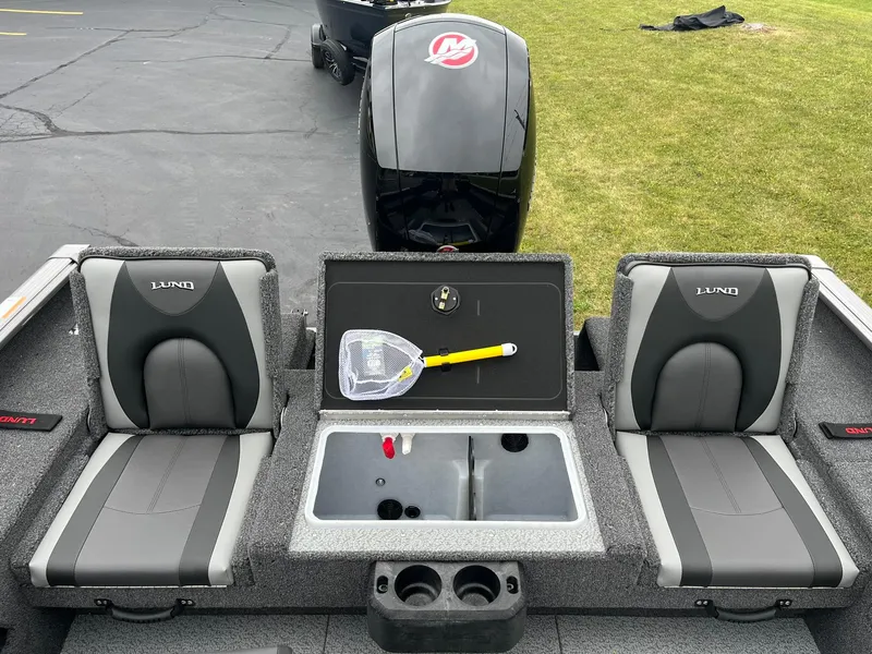 Slide: The Image of 2025 Lund 1875 Impact XS SS boat interior with seating and storage compartments. - 10