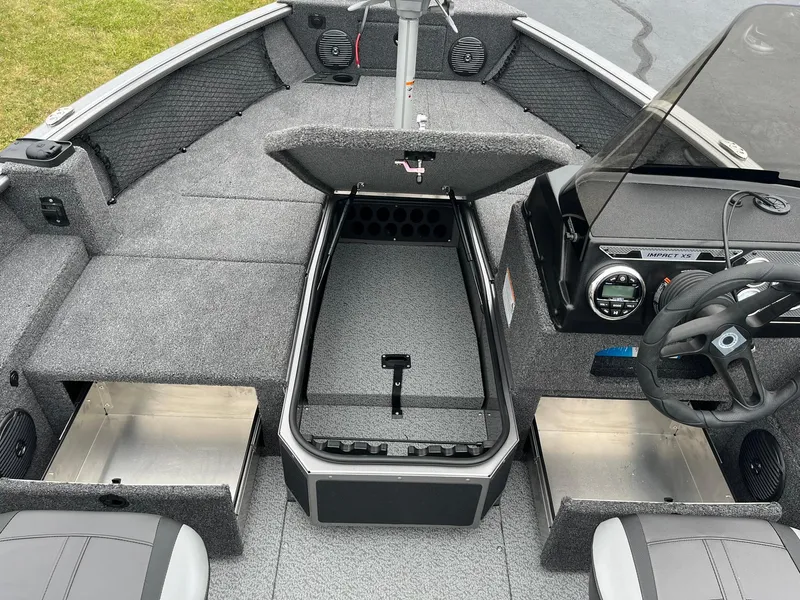 Slide: The Image of 2025 Lund 1875 Impact XS SS boat interior with storage compartments and steering console. - 12