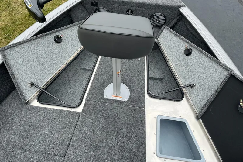 Slide: The Image of 2025 Lund 1875 Impact XS SS boat interior with storage compartments and seating. - 15