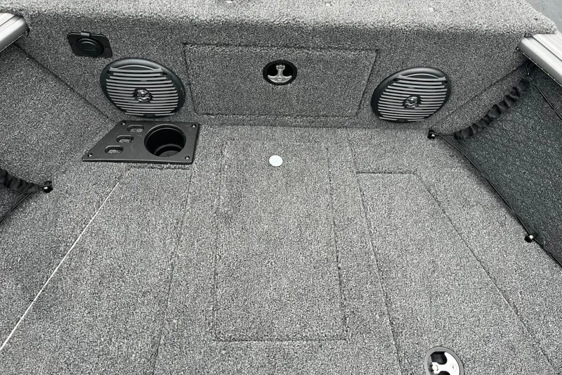 Slide: The Image of 2025 Lund 1875 Impact XS SS boat interior with carpeted flooring and speaker system. - 17