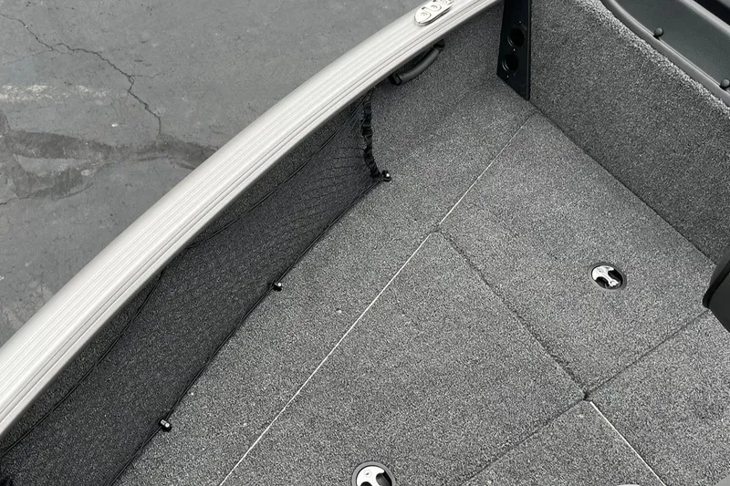 Slide: The Image of 2025 Lund 1875 Impact XS SS boat interior with gray carpeted flooring. - 18