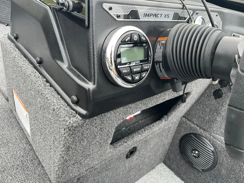Slide: The Image of 2025 Lund 1875 Impact XS SS boat dashboard with control panel and speaker. - 21