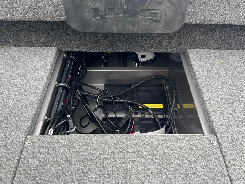 Slide: The Image of 2025 Lund 1875 Impact XS SS boat battery compartment with wiring. - 22