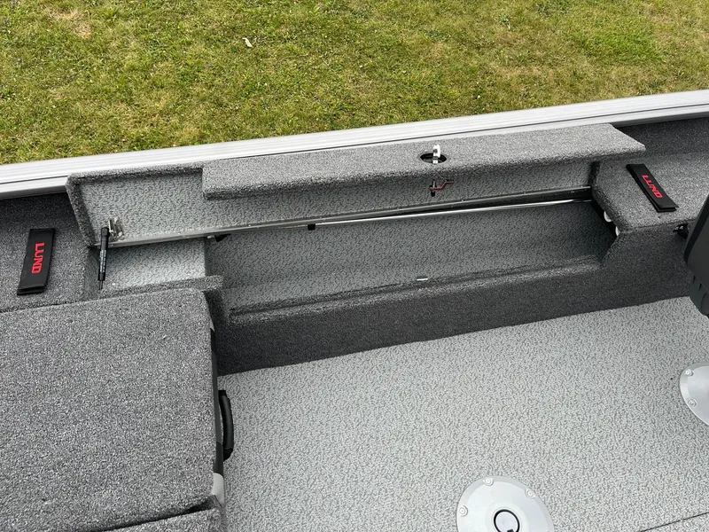 Slide: The Image of 2025 Lund 1875 Impact XS SS boat interior with storage compartments and seating. - 23