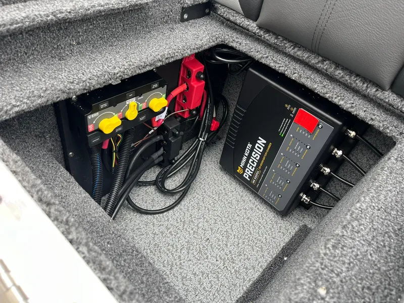 Slide: The Image of 2025 Lund 1875 Impact XS SS boat battery compartment with precision charger and wiring. - 29