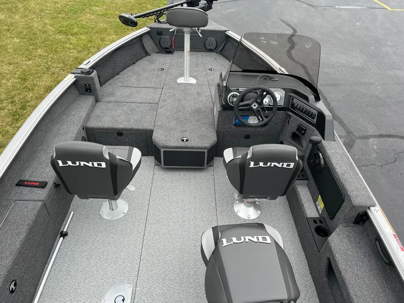 Slide: The Image of 2025 Lund 1875 Impact XS SS fishing boat interior with seating and steering console. - 6