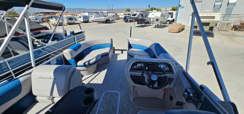 Slide: The Image of 2025 South Bay 224FCRLE pontoon boat interior at a marina. - 10