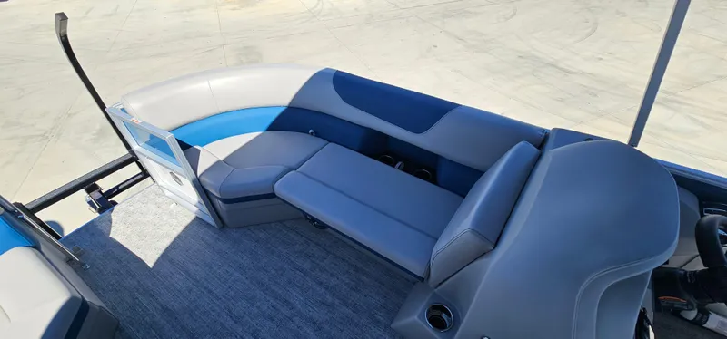 Slide: The Image of 2025 South Bay 224FCRLE pontoon boat interior with gray and blue seating. - 11