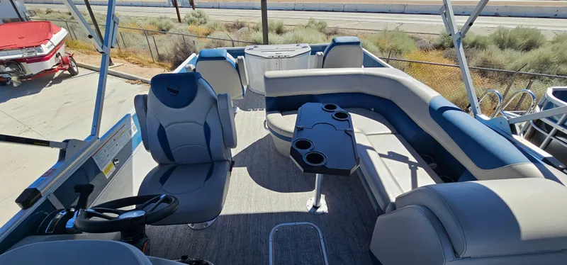 Slide: The Image of 2025 South Bay 224FCRLE pontoon boat interior with seating and cup holders. - 13