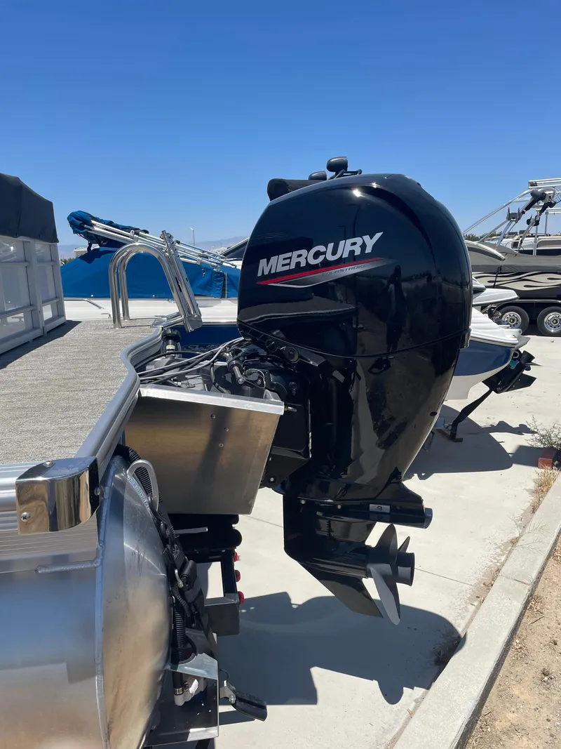 Slide: The Image of 2025 South Bay 224FCRLE boat with Mercury outboard motor in a sunny marina. - 20
