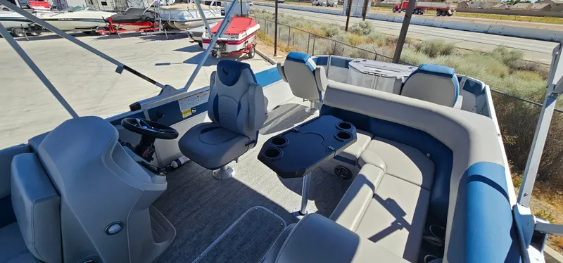 Slide: The Image of 2025 South Bay 224FCRLE pontoon boat interior with seating and steering console. - 3