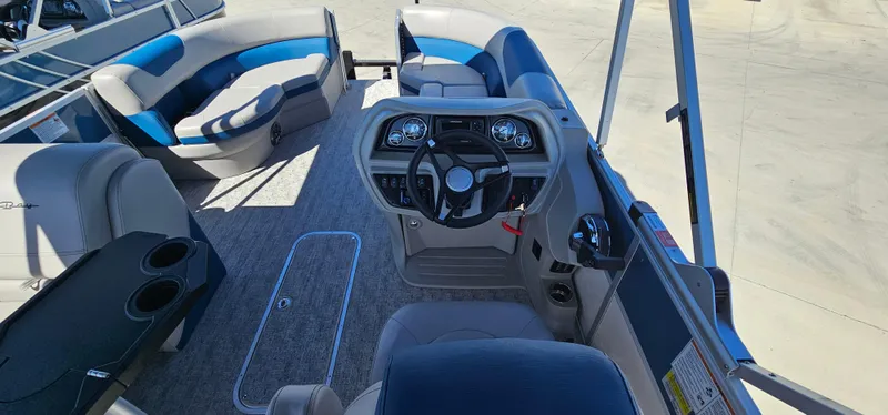 Slide: The Image of 2025 South Bay 224FCRLE pontoon boat interior with helm and seating. - 5