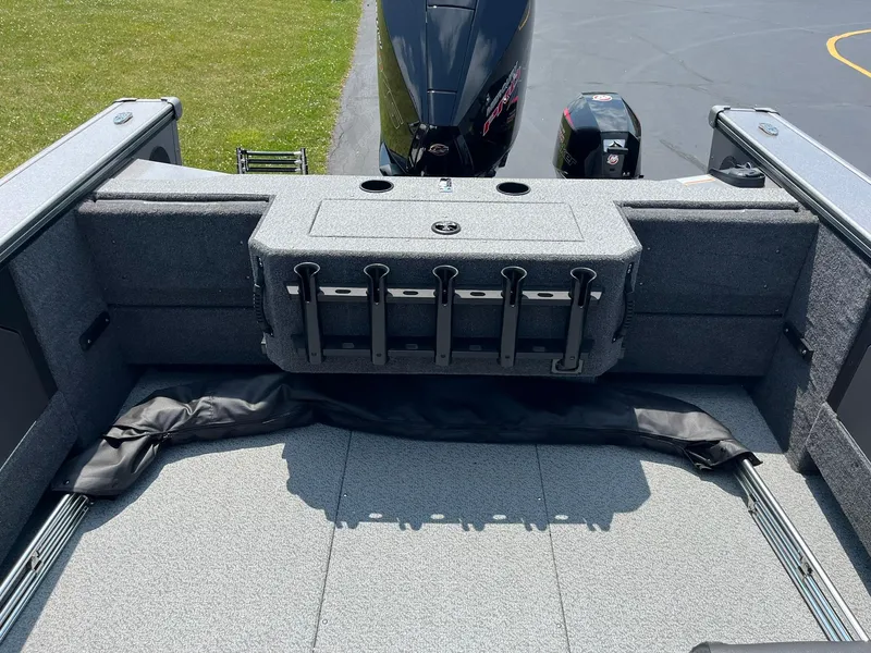 Slide: The Image of 2025 Lund 2075 Fisherman boat interior with rod holders and outboard motor. - 15