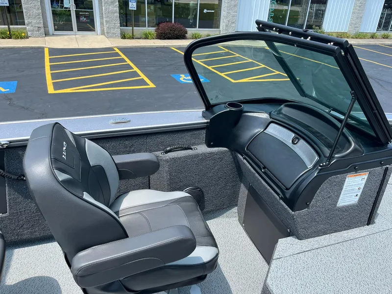 Slide: The Image of 2025 Lund 2075 Fisherman boat interior with captain's chair and windshield. - 19