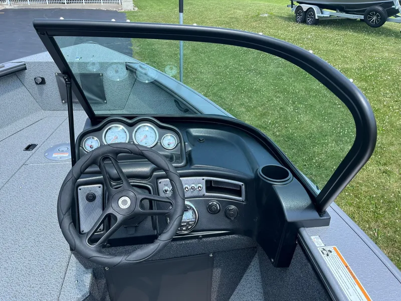 Slide: The Image of 2025 Lund 2075 Fisherman boat dashboard with steering wheel and instrument panel. - 21