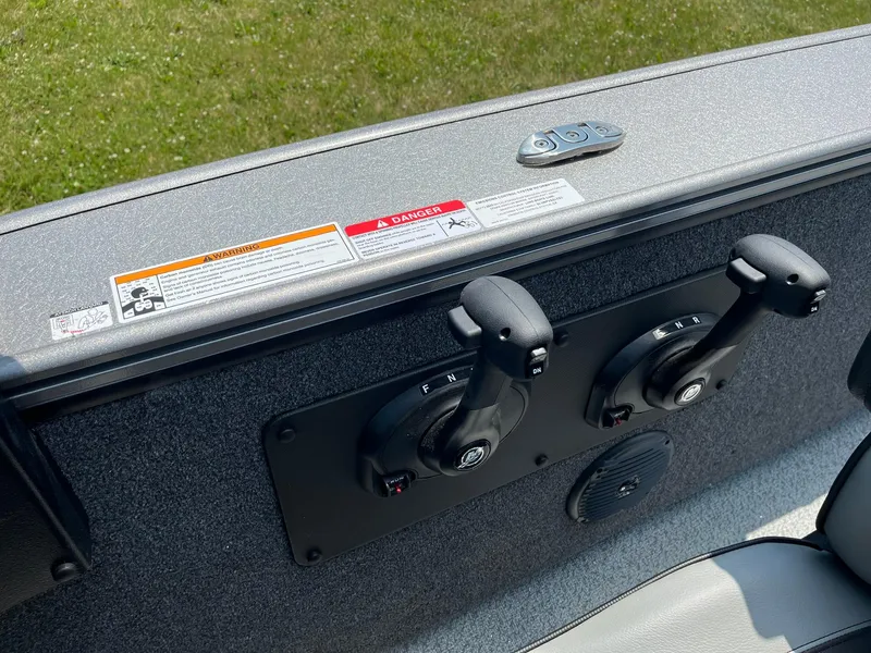 Slide: The Image of 2025 Lund 2075 Fisherman boat control panel with dual levers. - 29