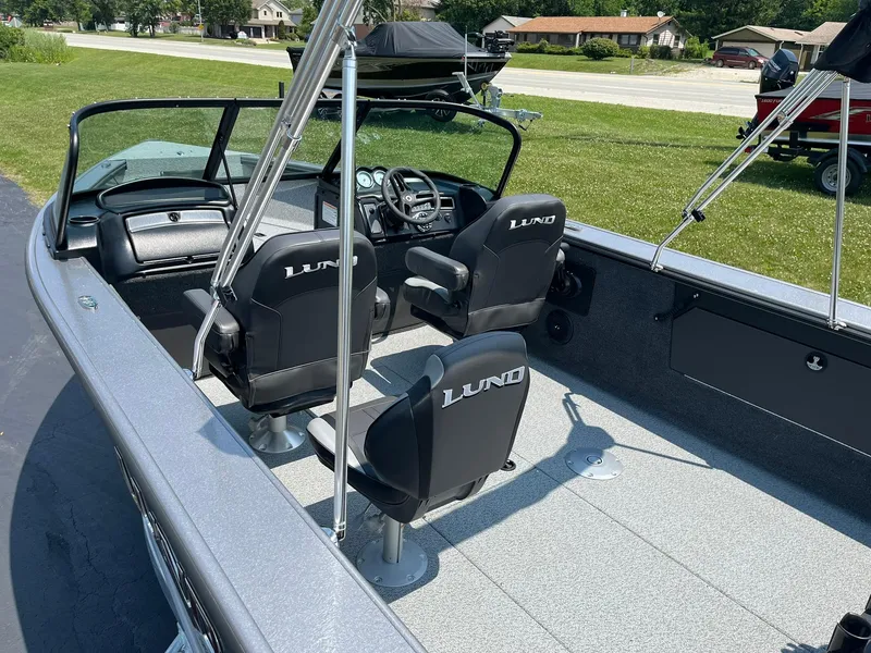 Slide: The Image of 2025 Lund 2075 Fisherman boat interior with black seats and steering console. - 6