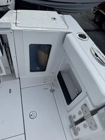 Slide: The Image of 2024 Blackfin 302CC boat interior with white and gray seating. - 10