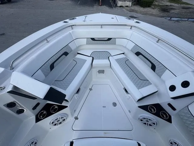 Slide: The Image of 2024 Blackfin 302CC boat with foldable rear seating and dual outboard engines. - 15